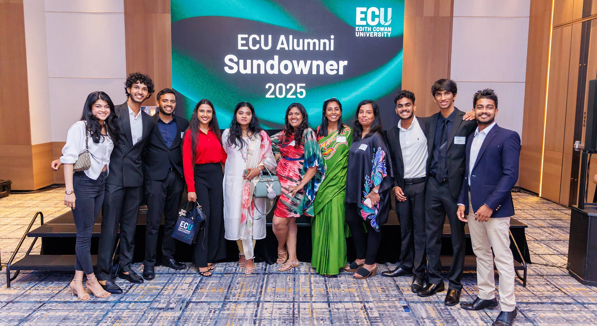 People standing in a line for a photo at a function