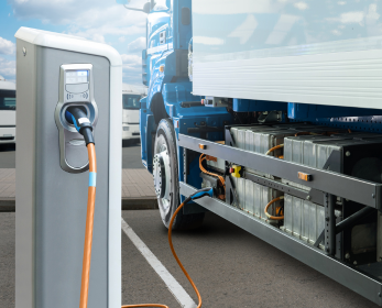 Photo showing an electric truck at an electric charging station