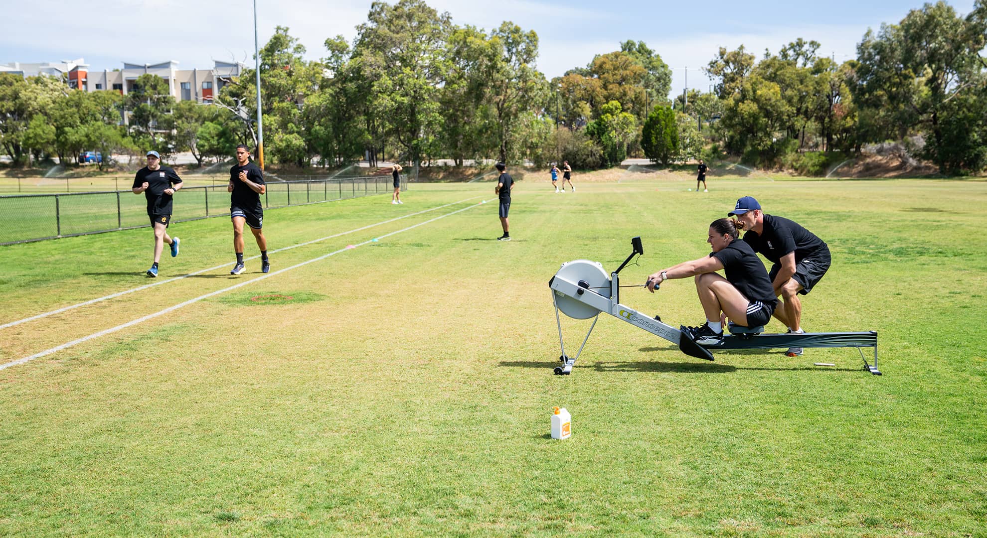 People working out on a green field.