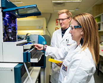 A photo of an employee working in the proteomics facility at ECU.