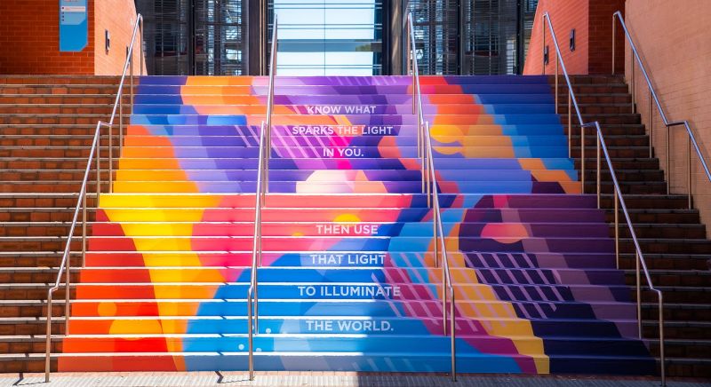 Colourful artwork on stairway between university buildings.