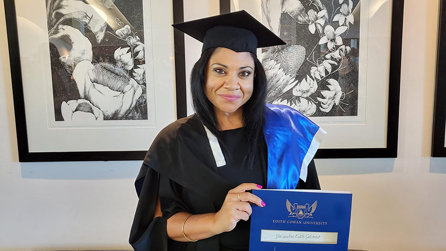 Woman in graduation gown and mortar board