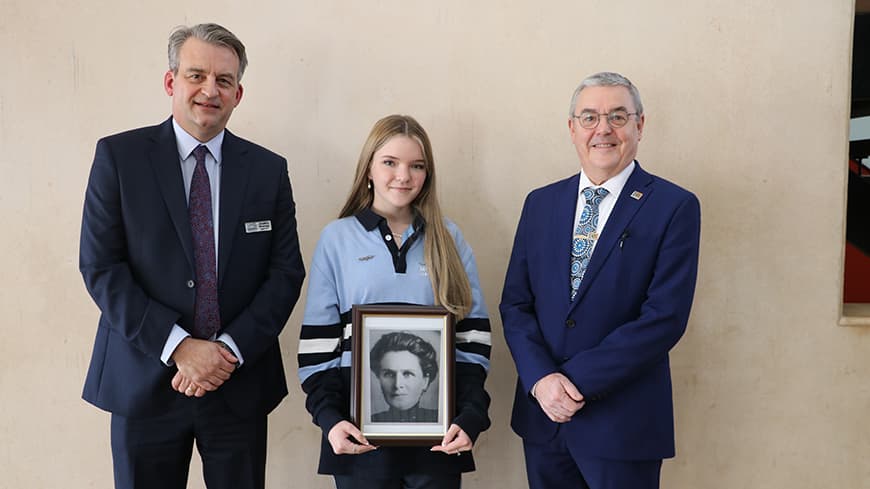 Mindarie Senior College Principal Jonathan Bromage, Year 12 Student Ayla Lewkowski and ECU Vice-Chancellor Professor Steve Chapman. Ayla is holding a framed black and white photograph of Edith Cowan.