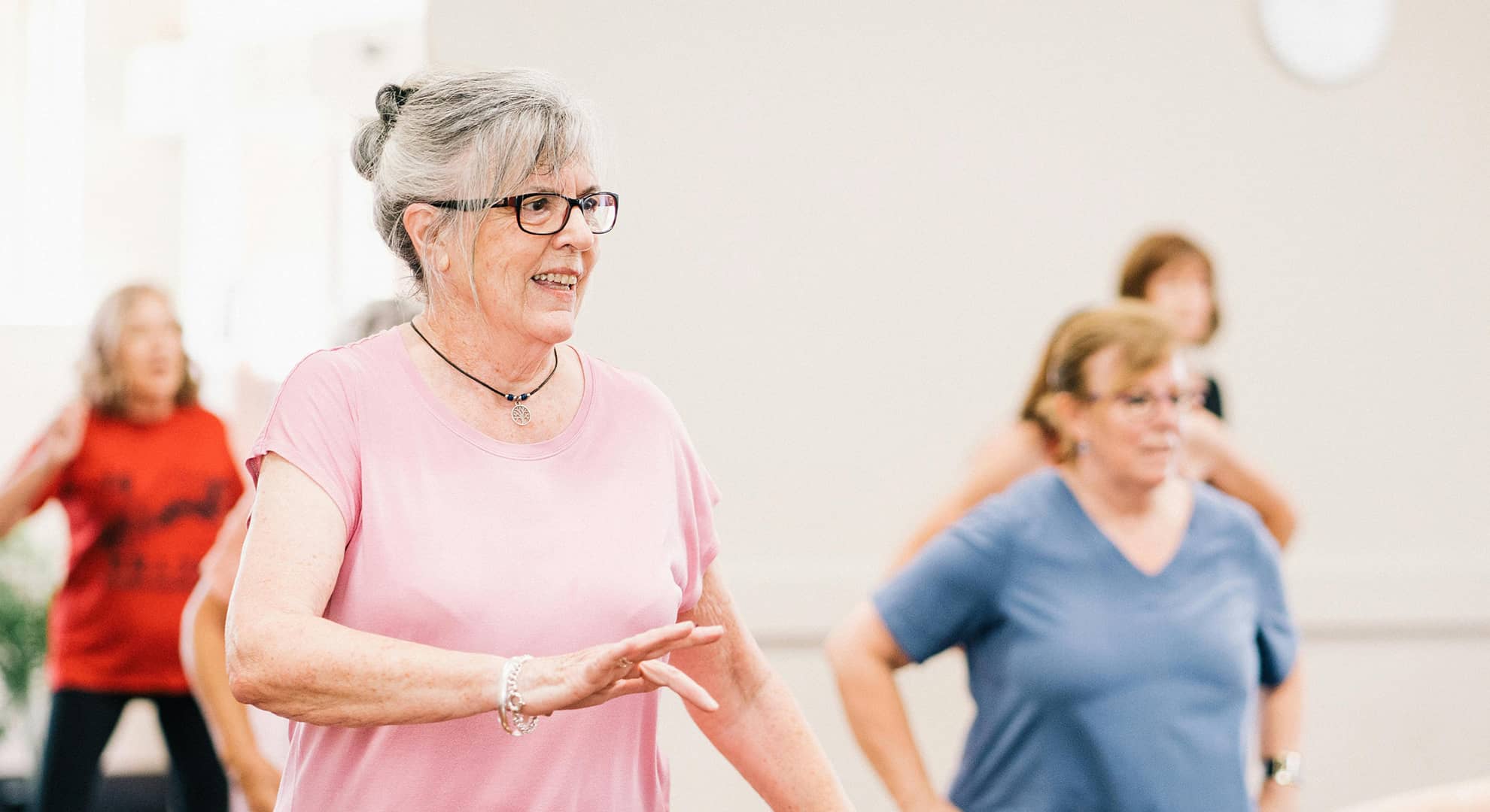 Women exercising in a gym class.
