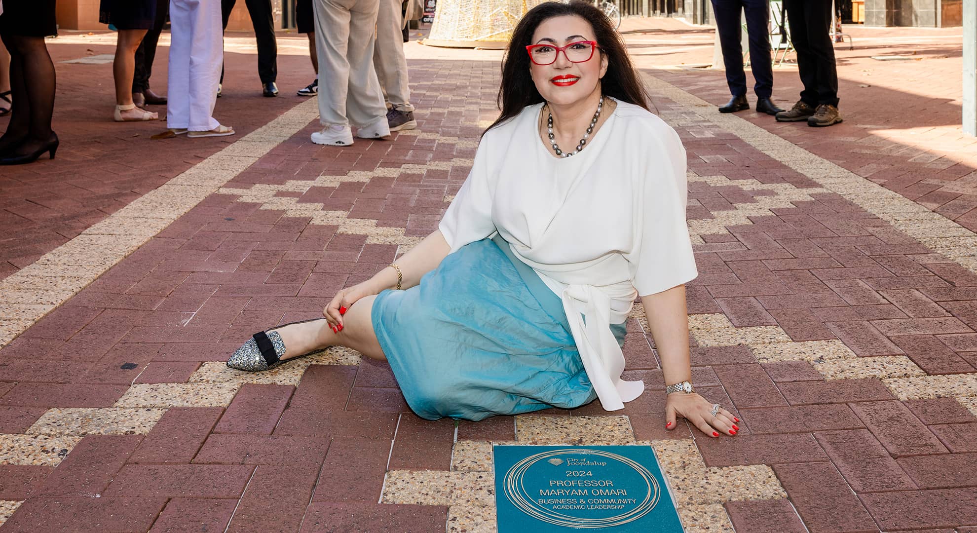 Woman sitting on the ground.