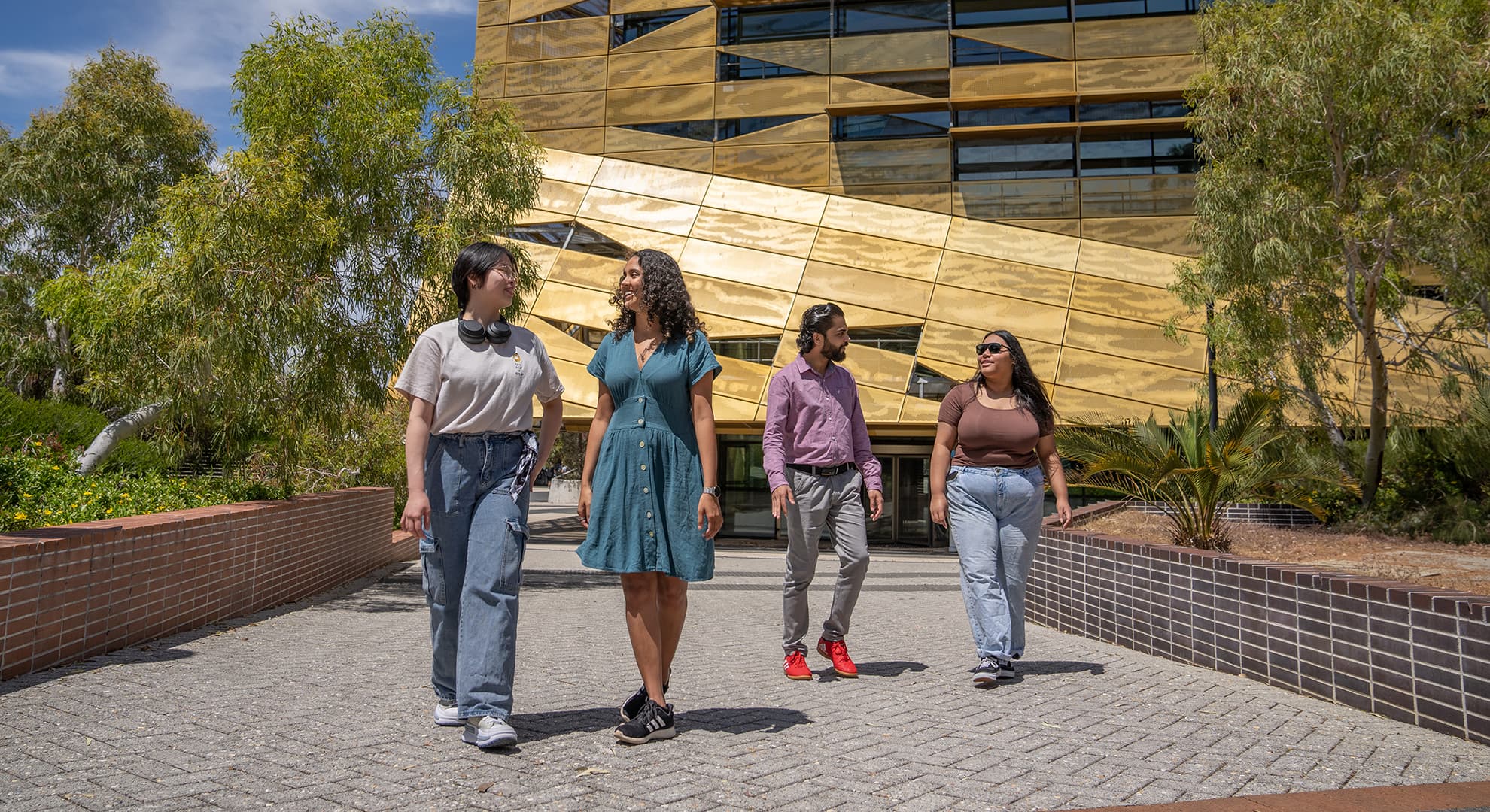 Four ECU students walk around the Joondalup Campus.