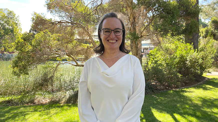 Student Phillippa Combrink stands by the lake at ECU