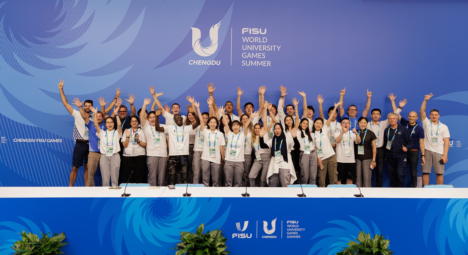 Competitors standing in front of FISU World Games banner