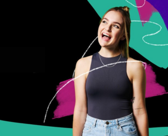 A young woman wearing a black sleeveless top and light denim jeans, smiling and looking excited. The background features bold, colourful abstract shapes and lines.