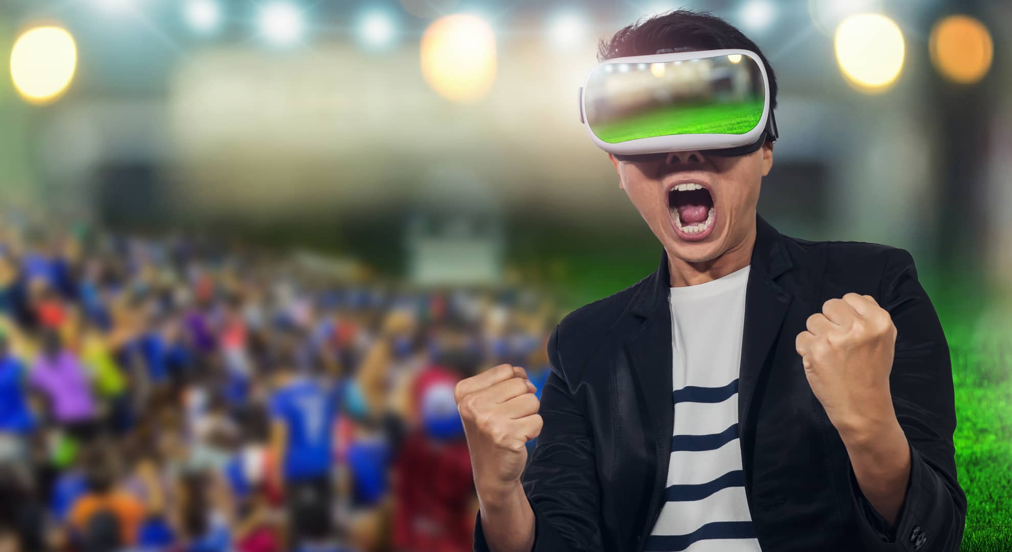 Man wearing a VR headset in a crowd of spectators.