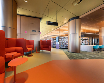 Interior view of ECU Library collections within Kaarlak at the ECU City Campus showing lounge seating, study areas, bookshelves and open collaborative spaces.