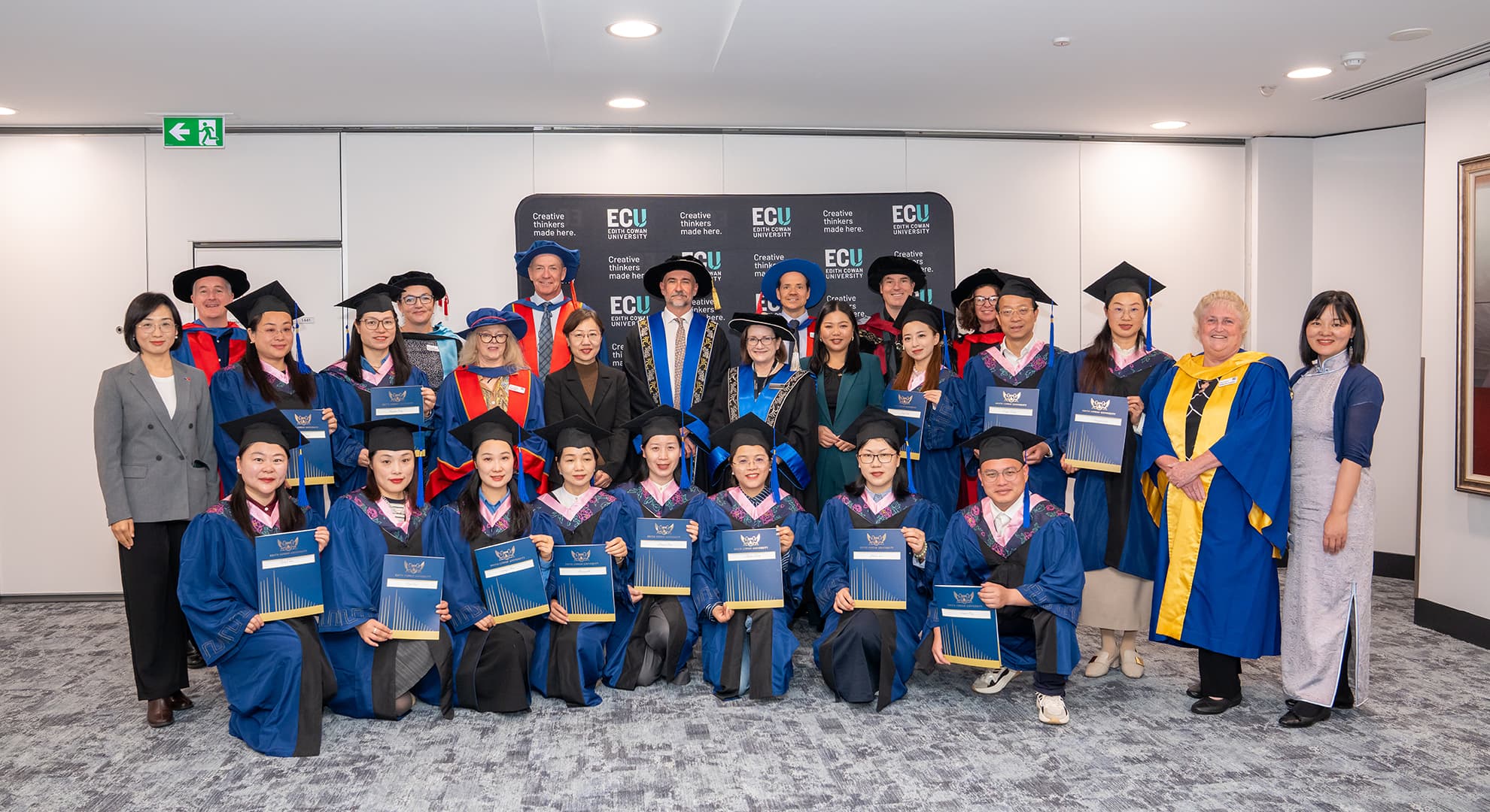 A group of people wearing graduation regalia.