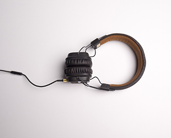A birds-eye view of a pair of headphones on a white background.
