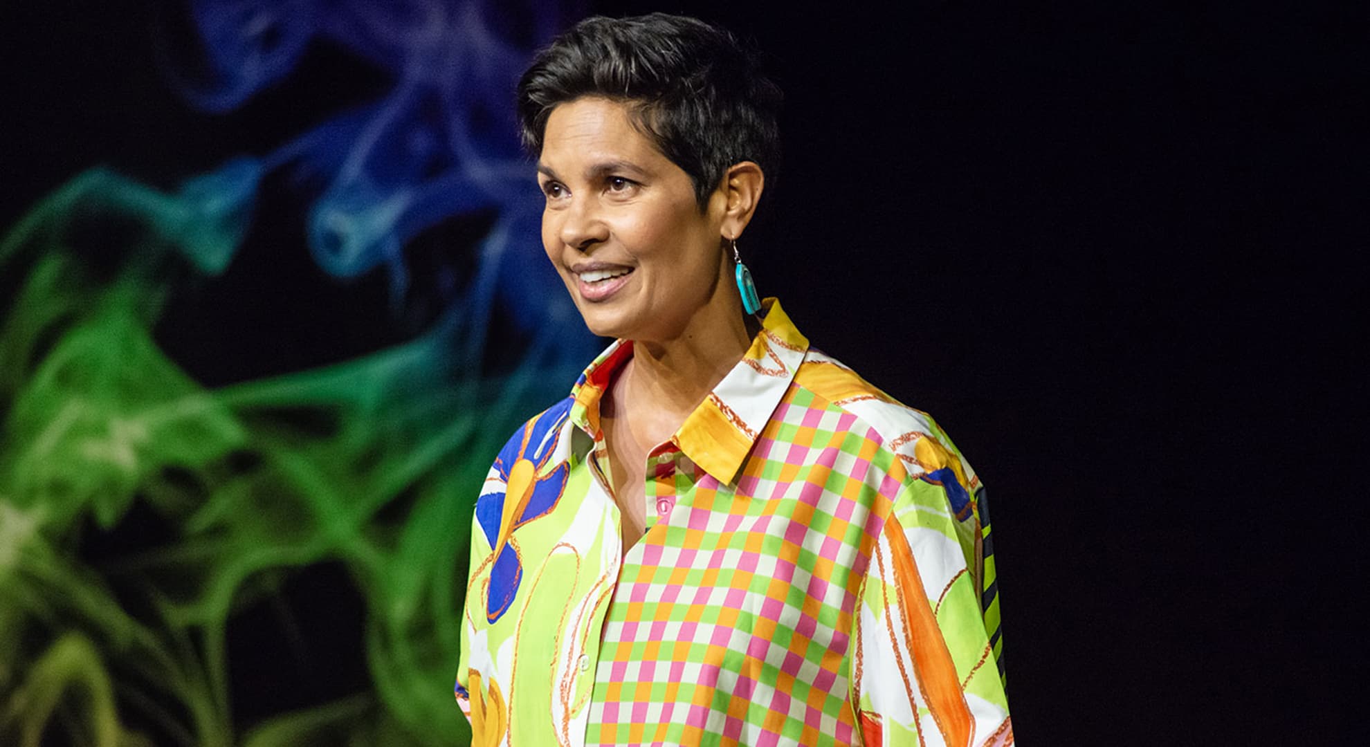 Narelda Jacobs speaking on stage.