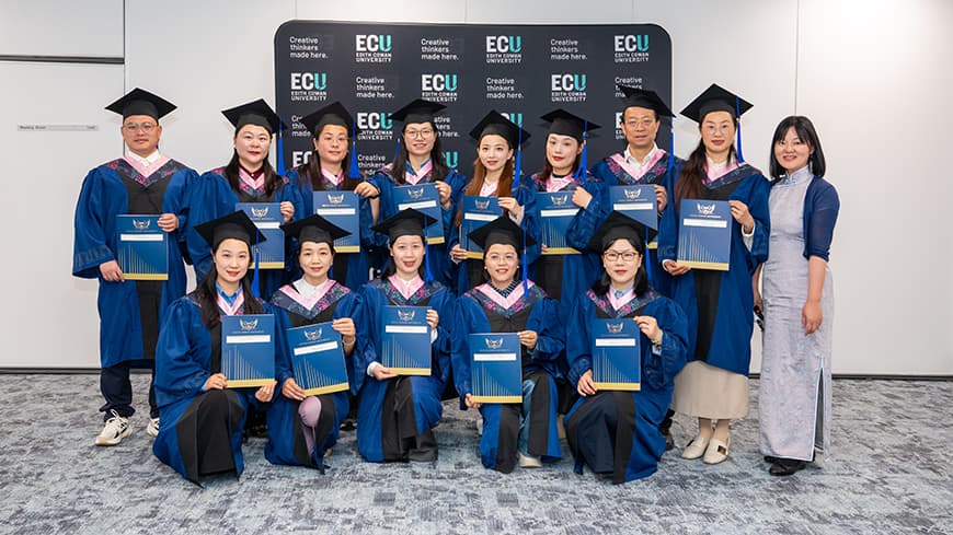 A group of people wearing graduation regalia.
