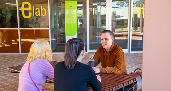 Students sitting at table outside the elab on ECU South West campus