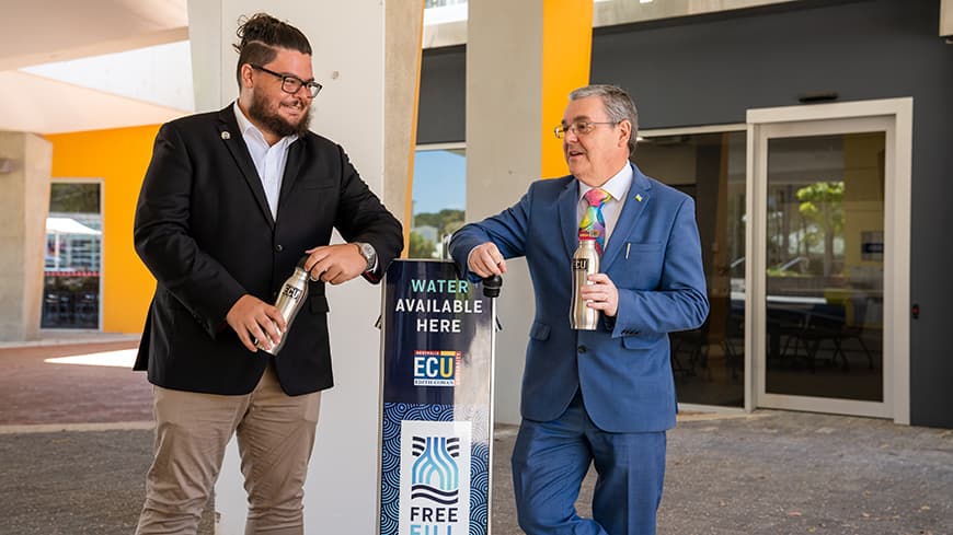 Mr Reynolds and Professor Chapman talking while holding their reusable ECU water bottles at an ECU water refill station.