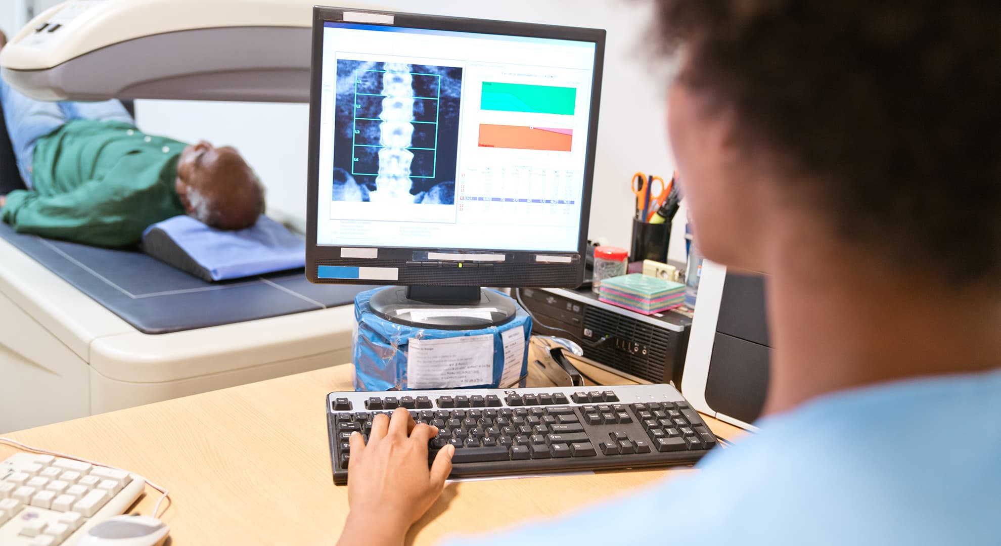 A bone density machine scanning a patient.