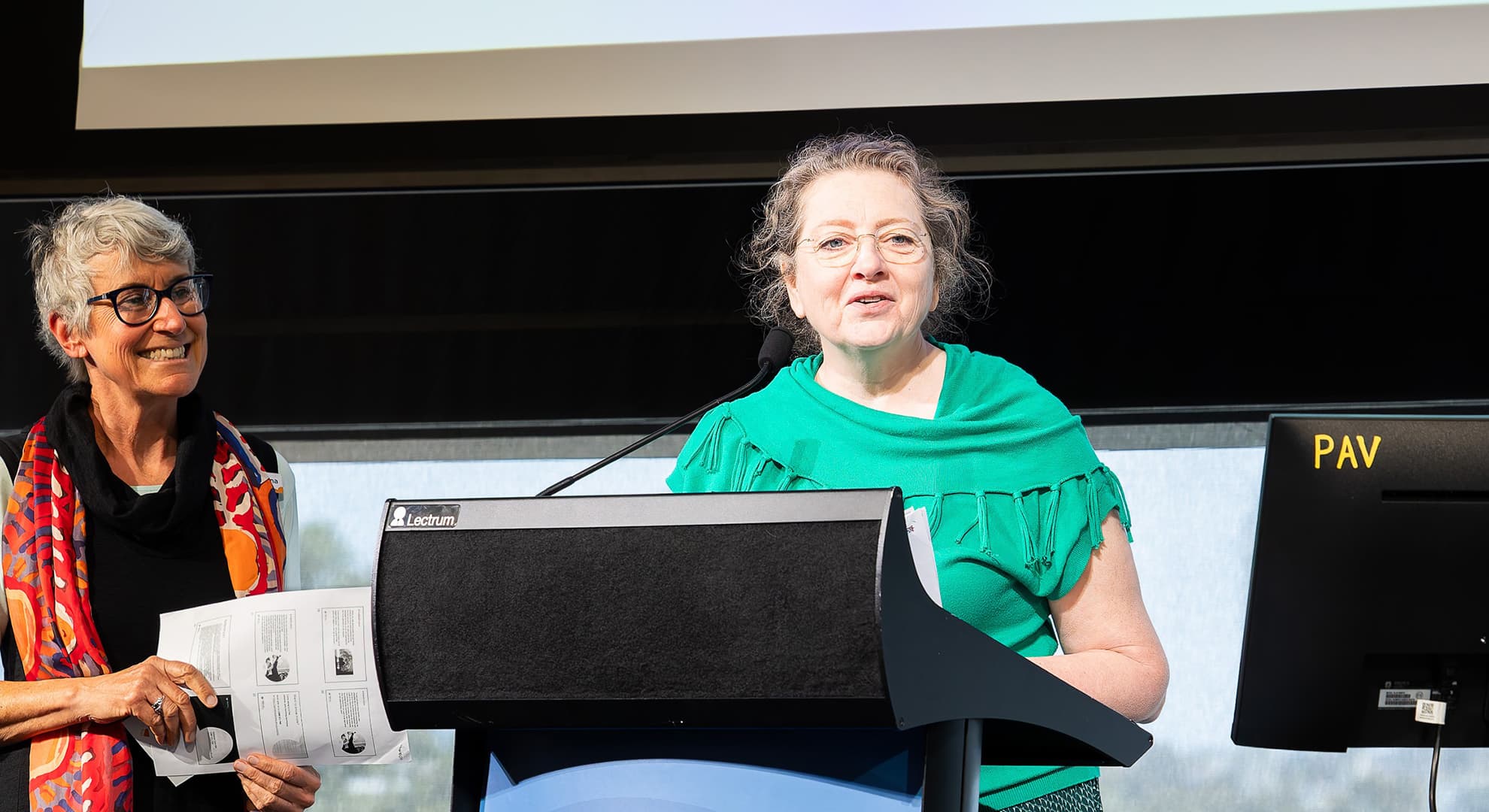 Women on stage talking at conference