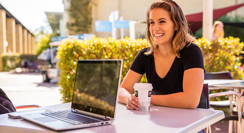 Woman having coffee outside