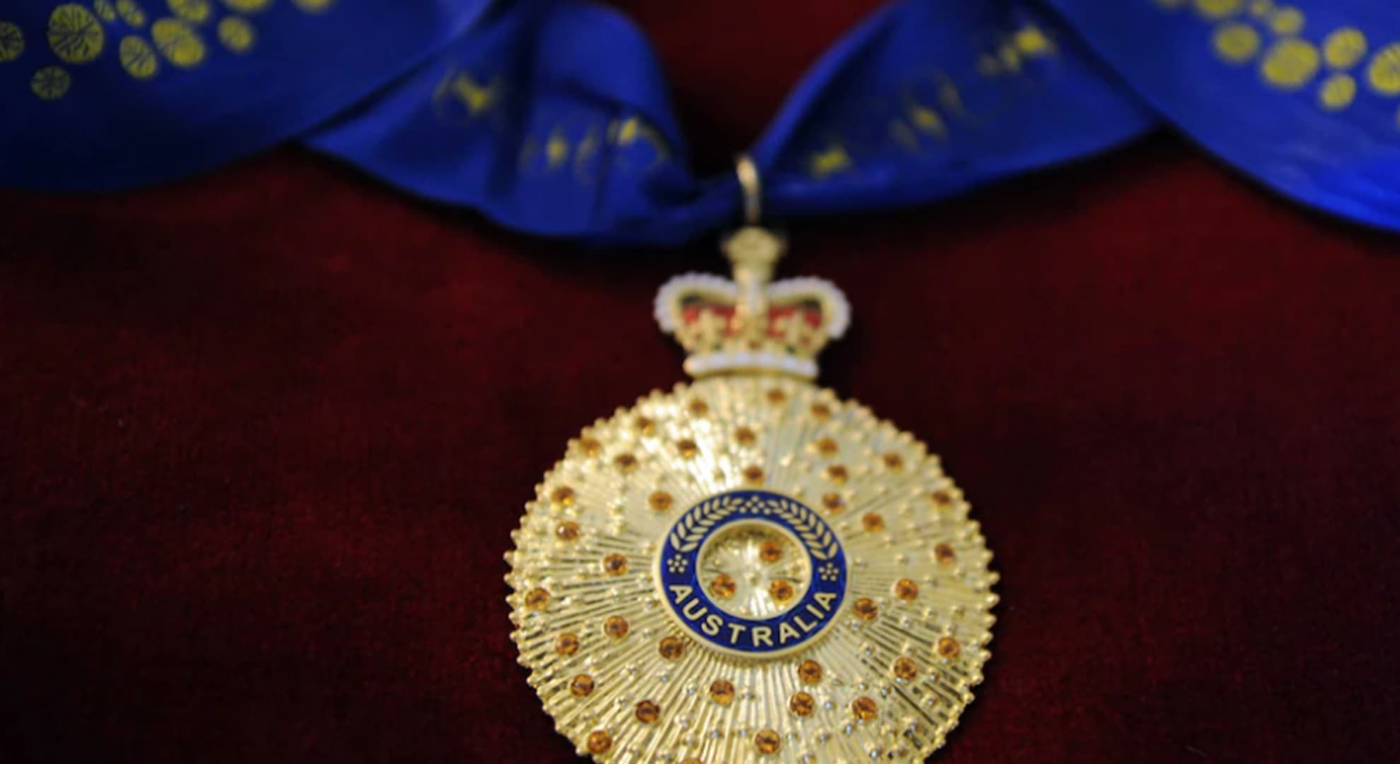 Australia Day Honours medal on red velvet