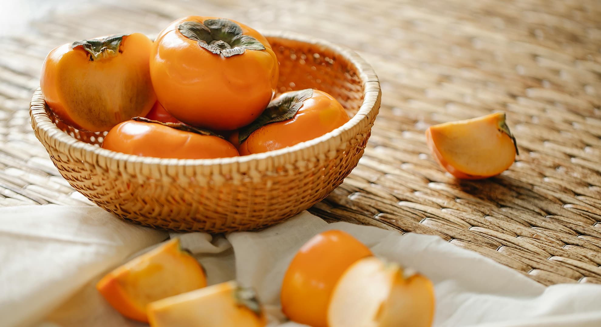 Persimmons in a woven basket