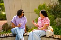 Two women sitting in the Health and Wellness Garden at the Joondalup Campus