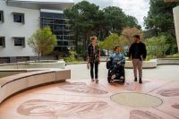 Three people entering the Health and Wellness Garden at the Joondalup Campus.