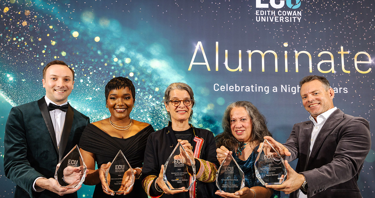 A group of recipients holding awards.