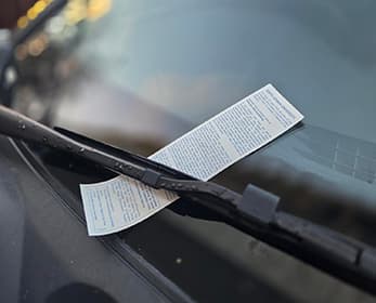 parking ticket on a car windshield.