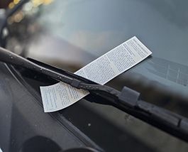 parking ticket on a car windshield.