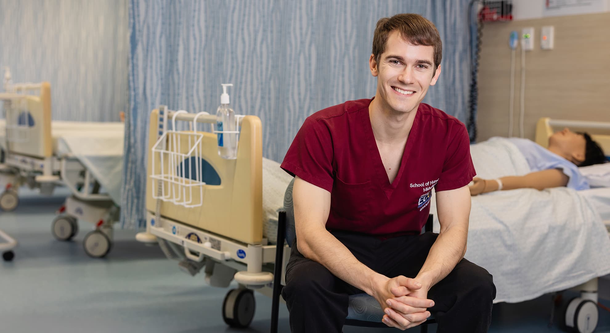 man sitting in a hospital training ward.