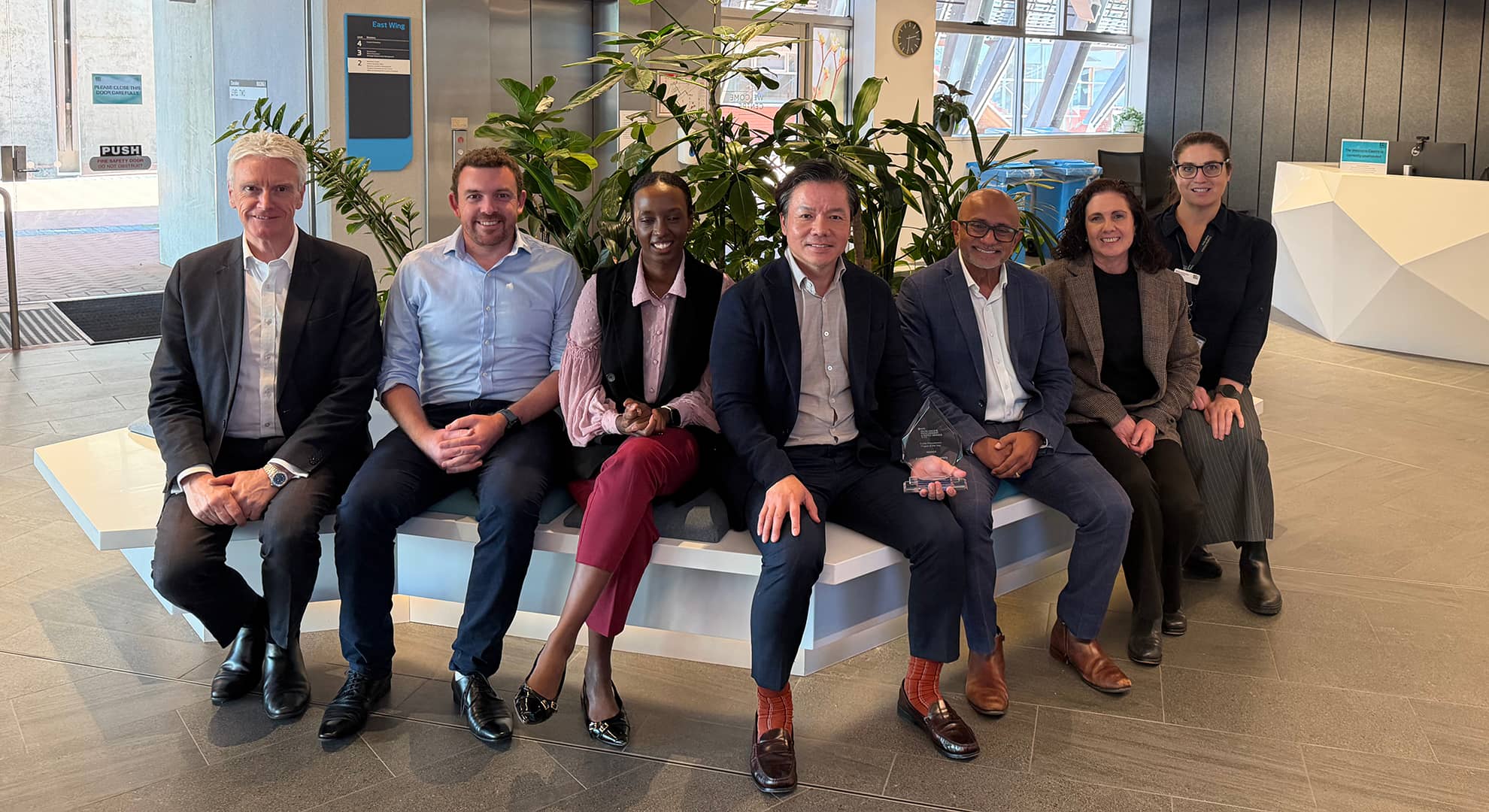 Procurement team: David Shaw, Curt Blakey, Ashenef Walsh, Andrew Kong, Brad Francis, Nirit Marom and Lani Levi sitting together in a line
