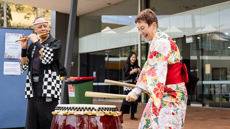 ECU Vice-Chancellor Clare Pollock playing a drum at the Japan Festival. Image: Kylie Plunkett.