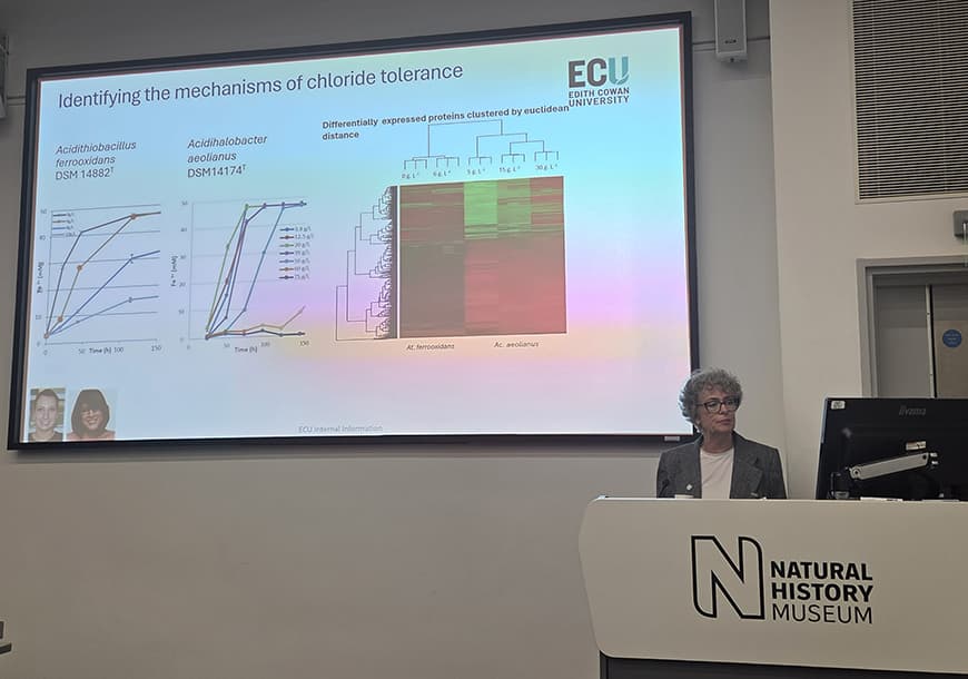 Female presenting at conference inside the Natural History Museum