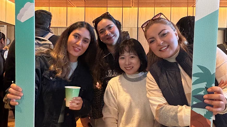 Four international students framed by the ECU logo