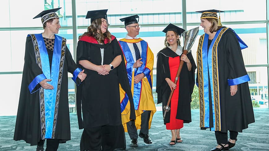 Committee with full regalia laughing together