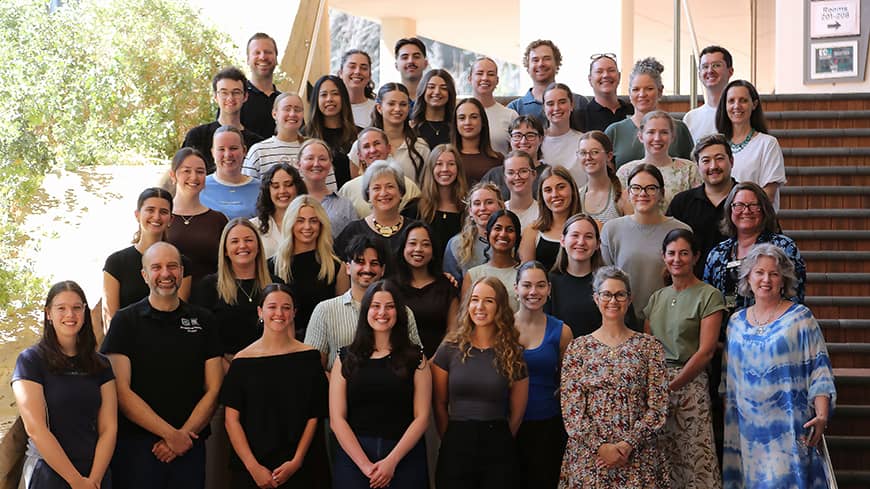 The second and fourth year cohort arranged on steps