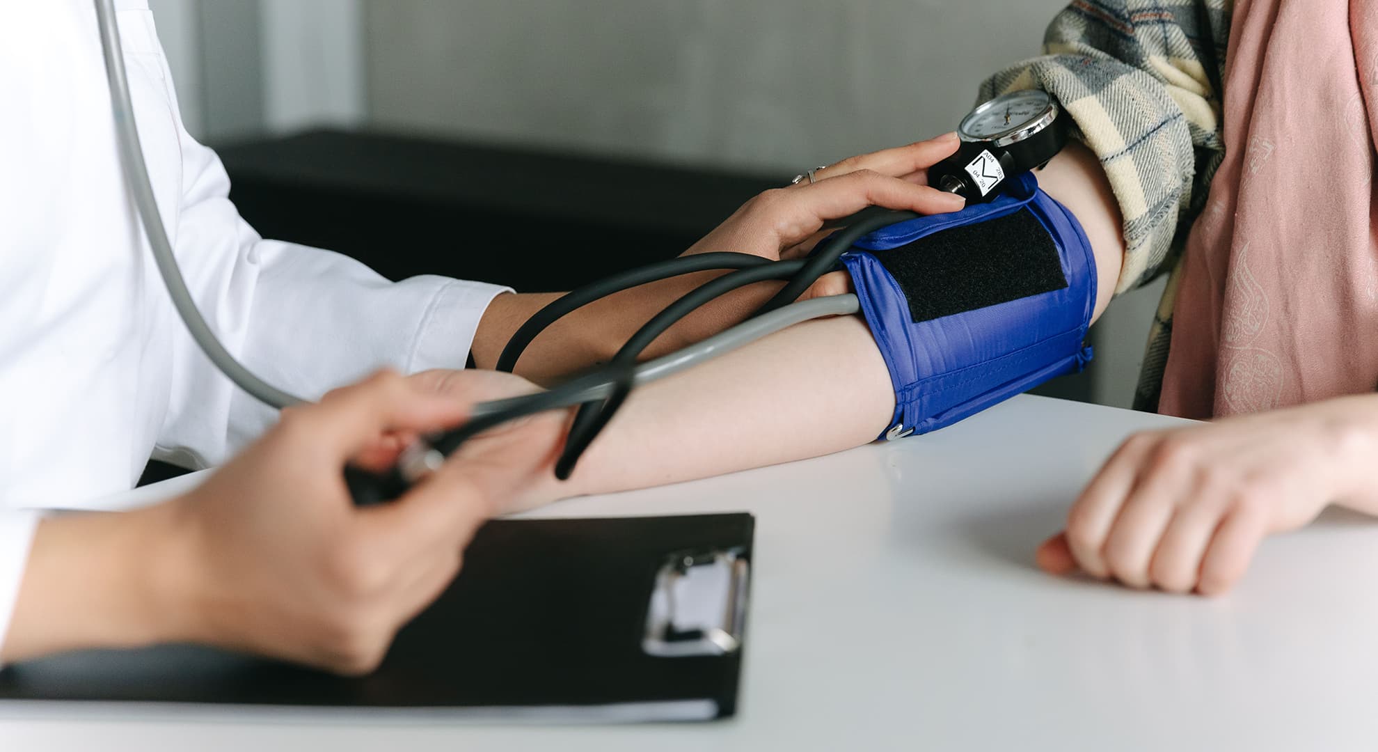 A doctor taking the blood pressure of a patient