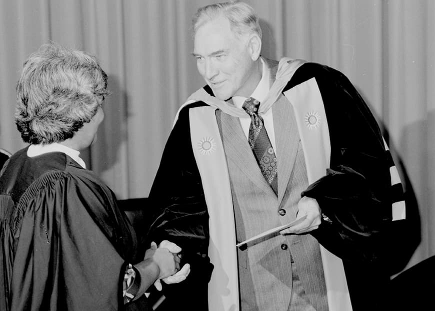 Man handing certificate to student