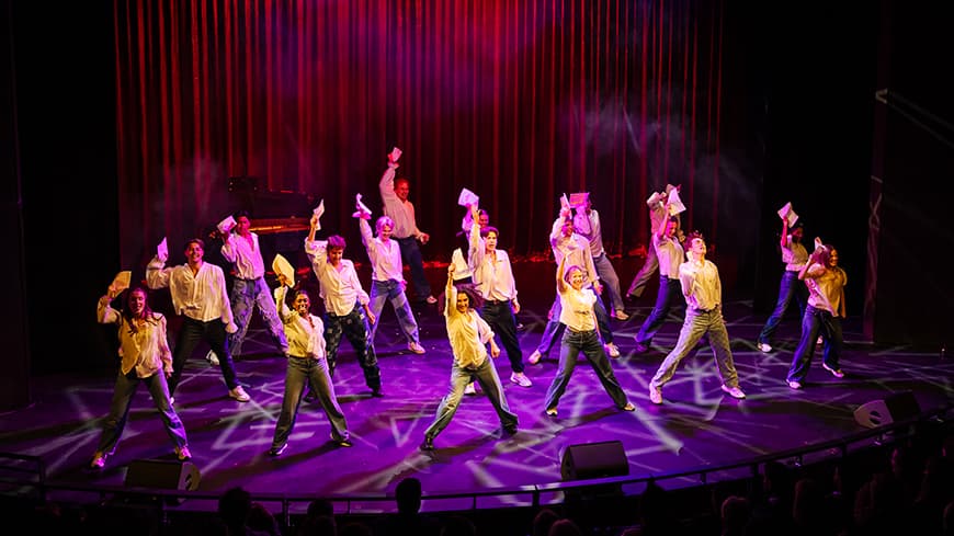 Dancers performing on a stage.