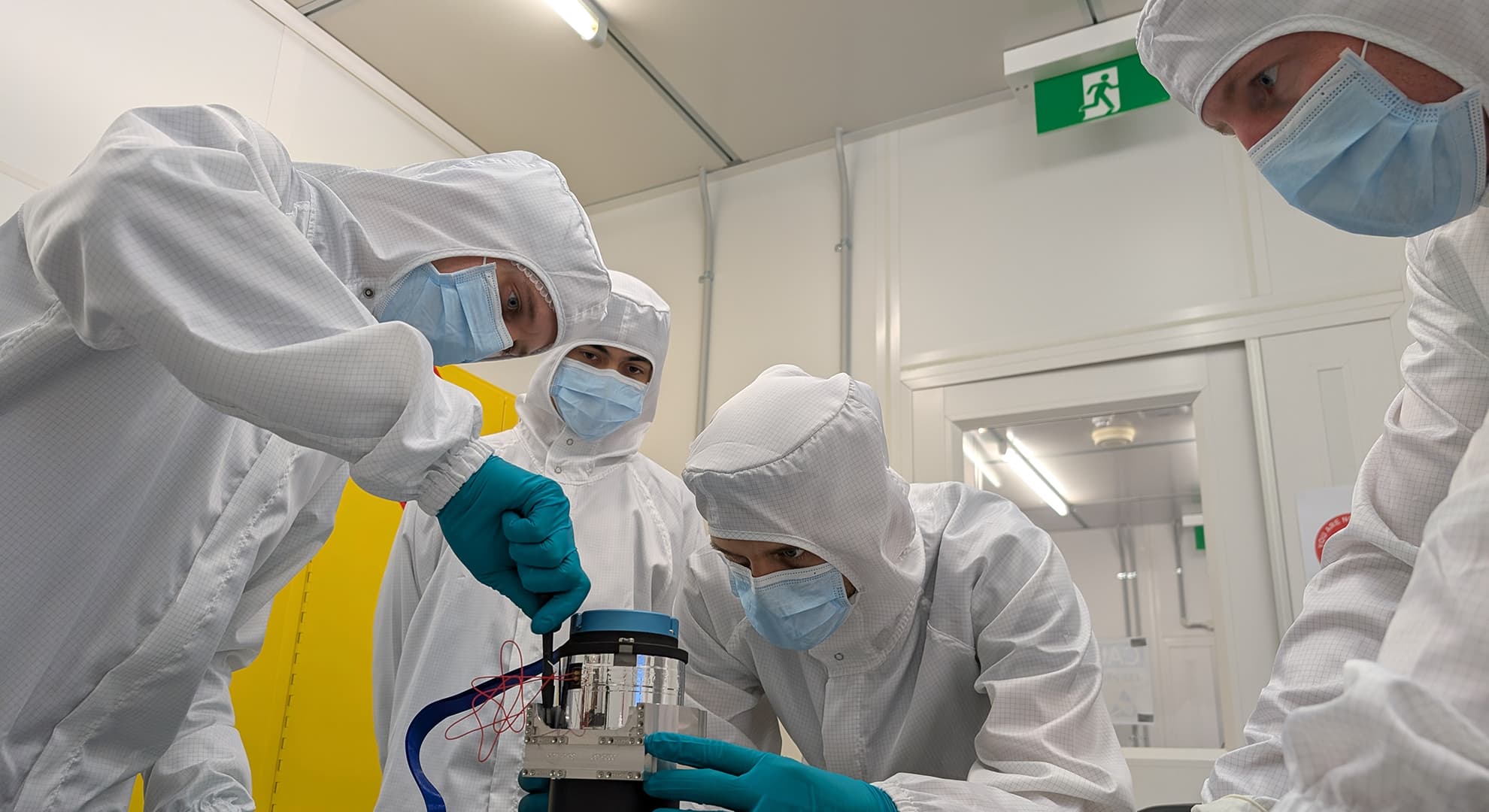 Students helping international experts build a satellite