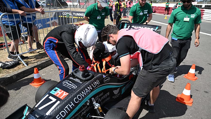 A racing car being worked on in the pit