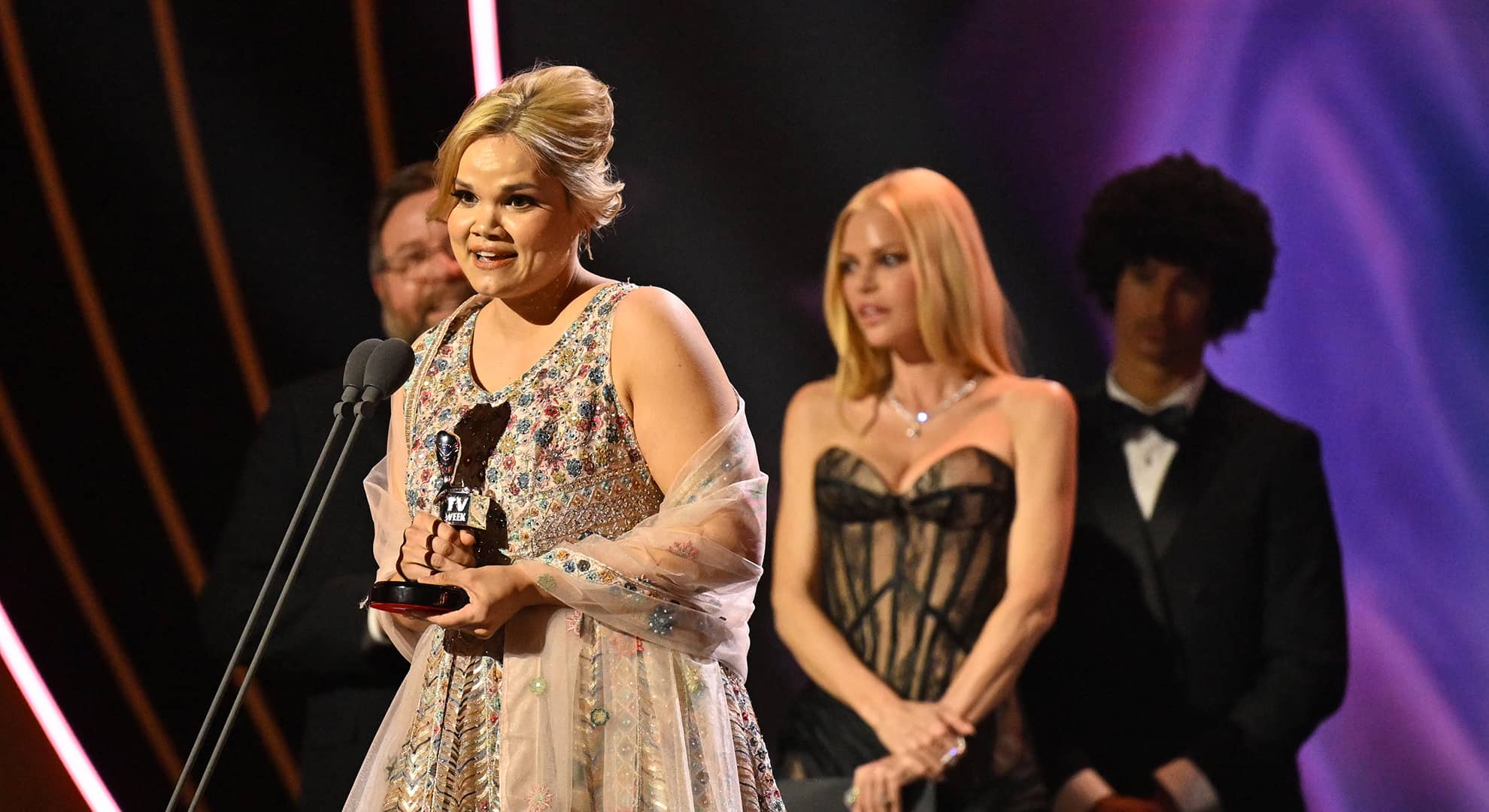 Woman on stage accepting a Logie award.