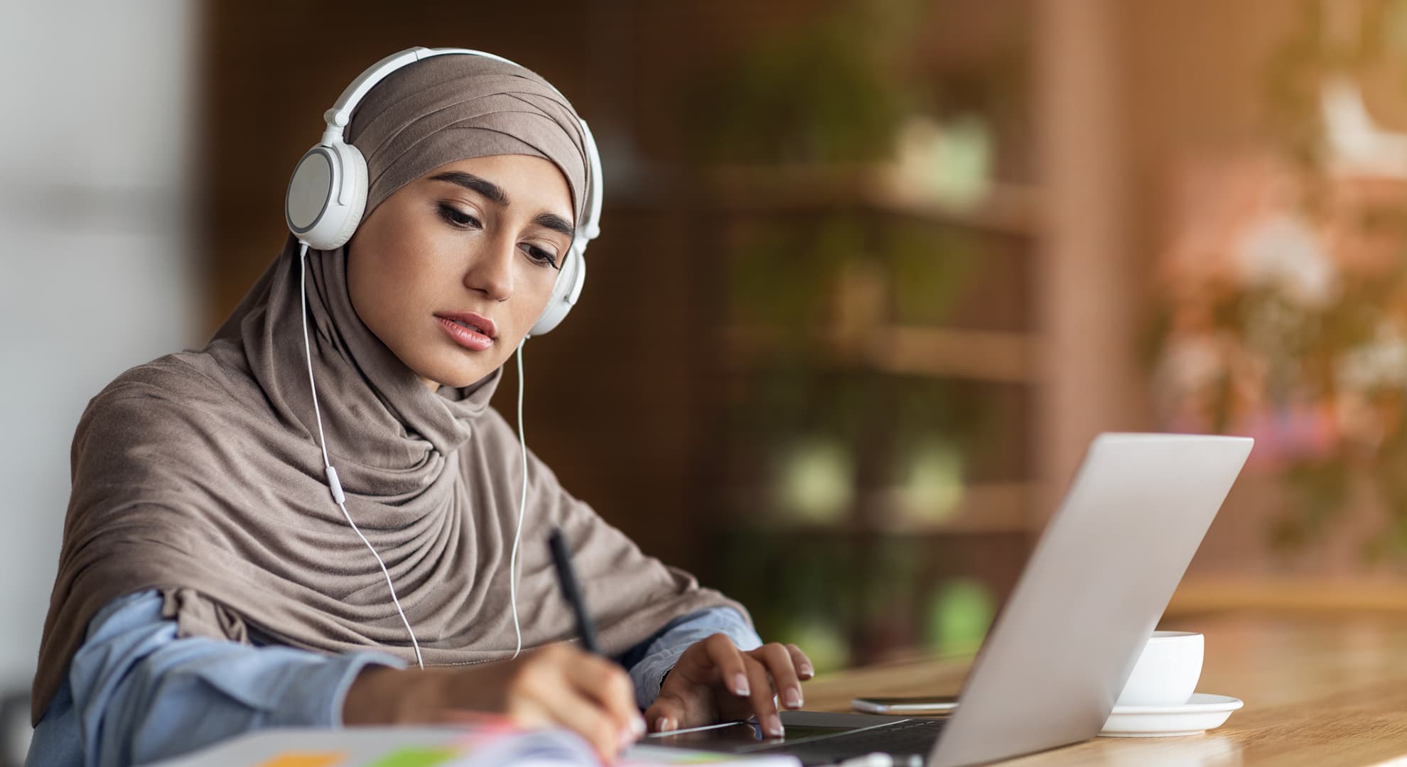 Student wearing headphones while studying.