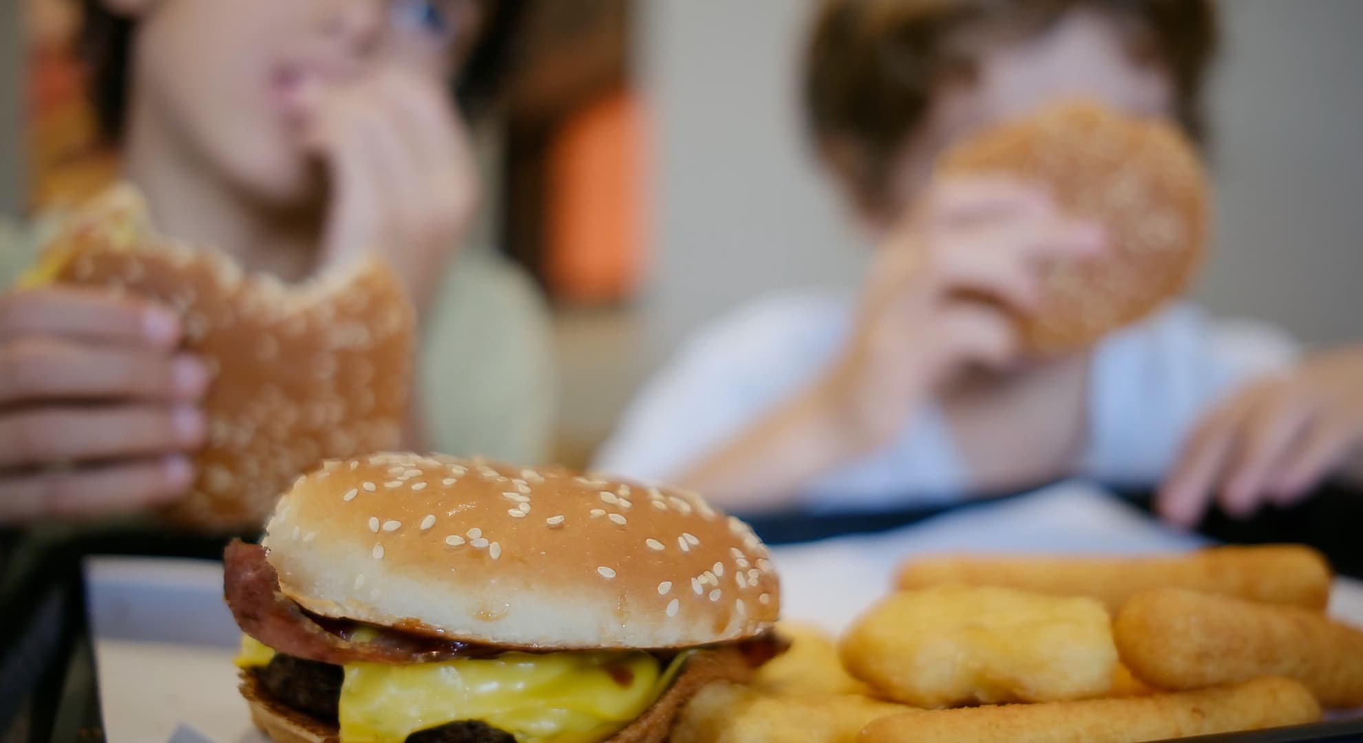 Children eating burgers and nuggets