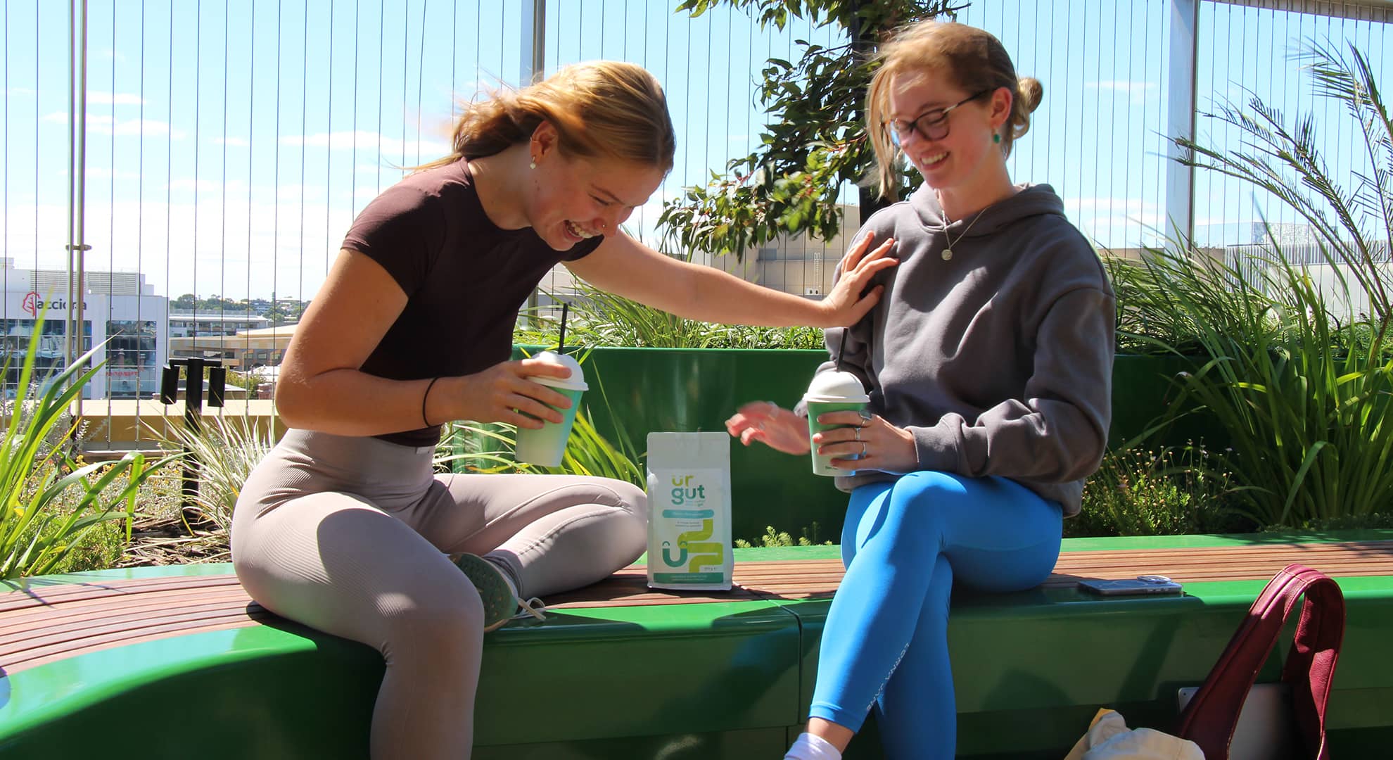 Two young women with a packet of ur gut