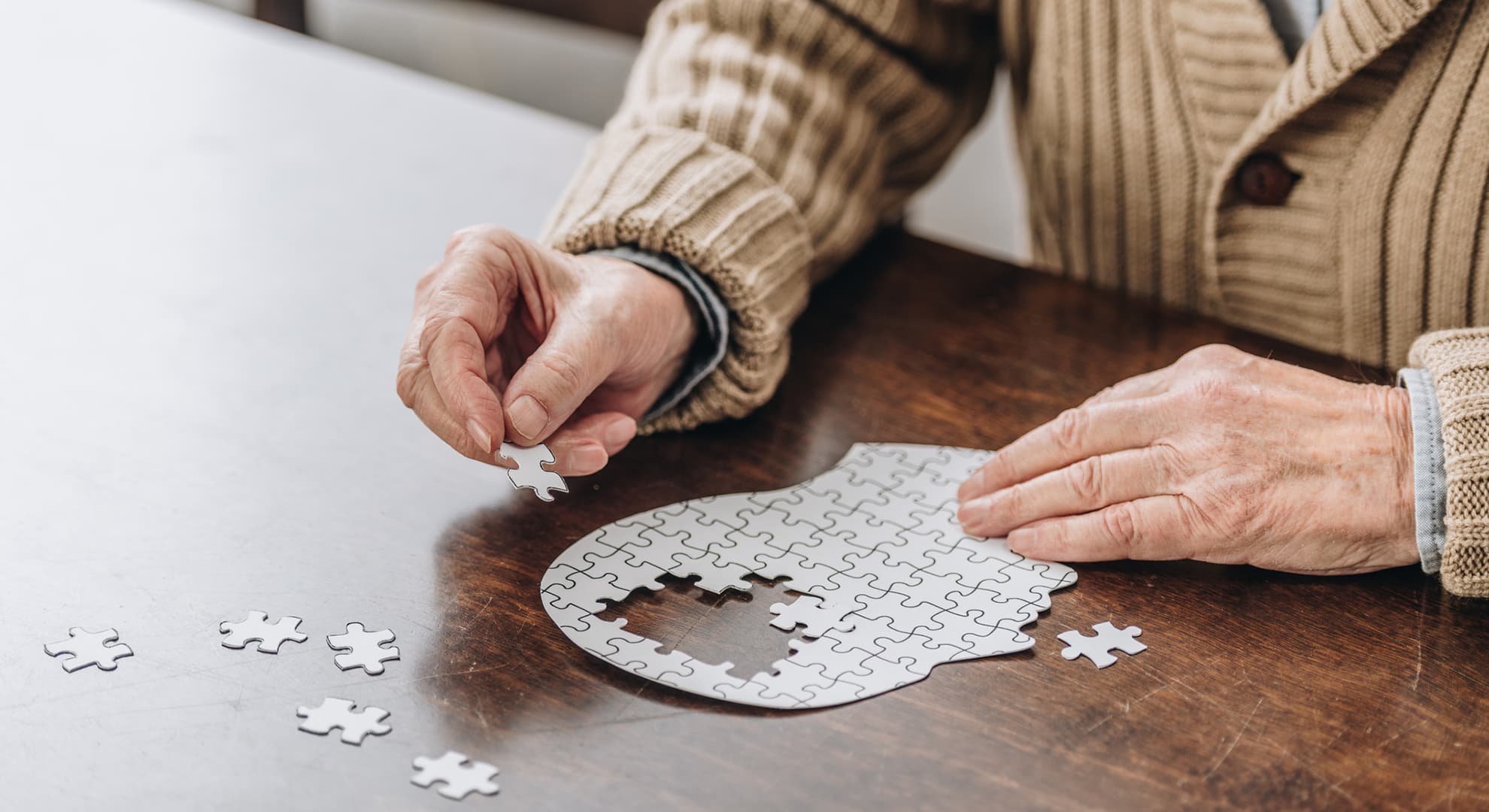 Elderly man doing a jigsaw puzzle