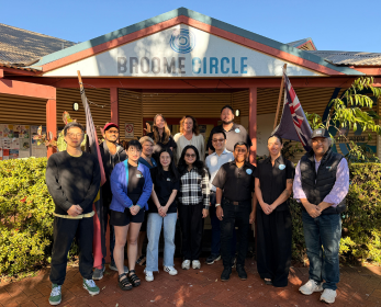 Group of people standing in front on the Broome Circle building