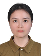 Photo of a female PhD student with dark hair tied back in brown button shirt